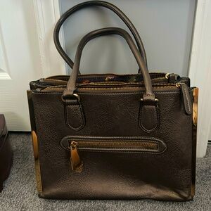 Tote Bag metalic green with gold color hardware. Inside had three compartments.